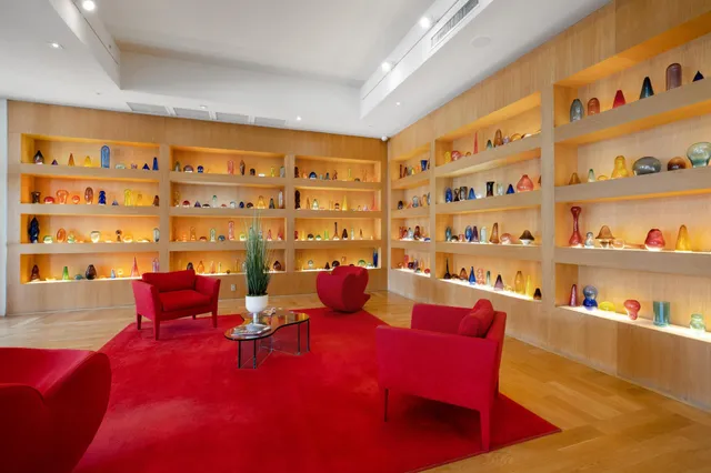 a living room with furniture and a book shelf