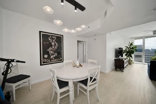 a view of a dining room with furniture and a chandelier