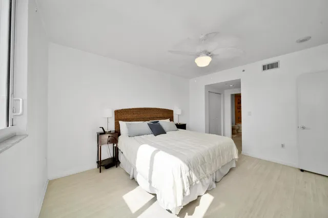 a bedroom with a bed and a night stand