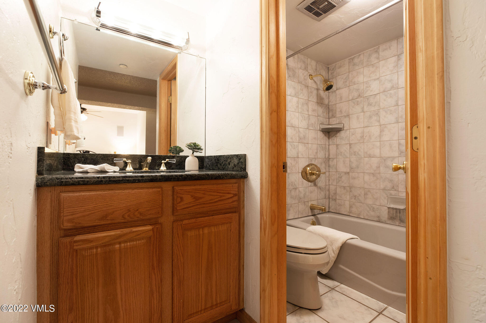 9 Vail Road, Unit 15 Vail, CO 81657 - Photo 11 of 18 a bathroom with a granite countertop sink toilet and shower