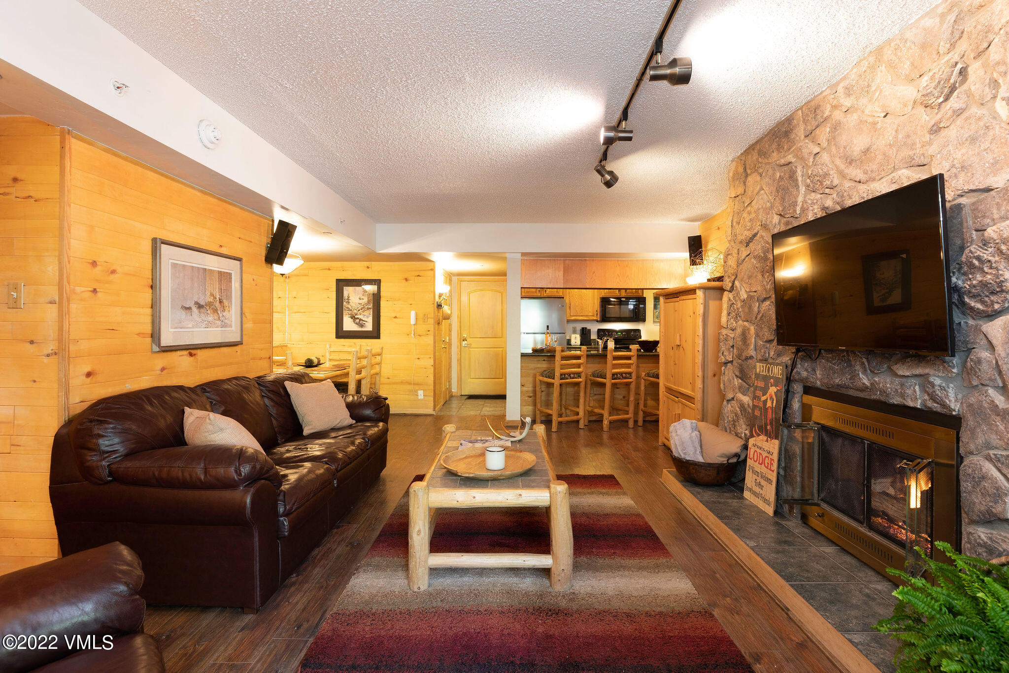 9 Vail Road, Unit 15 Vail, CO 81657 - Photo 3 of 18 a living room with furniture and a flat screen tv