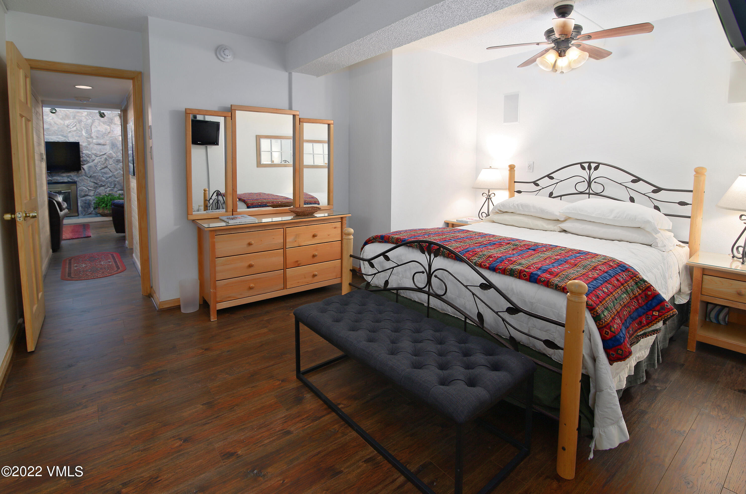 9 Vail Road, Unit 15 Vail, CO 81657 - Photo 10 of 18 a bedroom with a bed and a chandelier