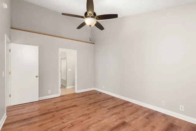 a view of empty room with wooden floor