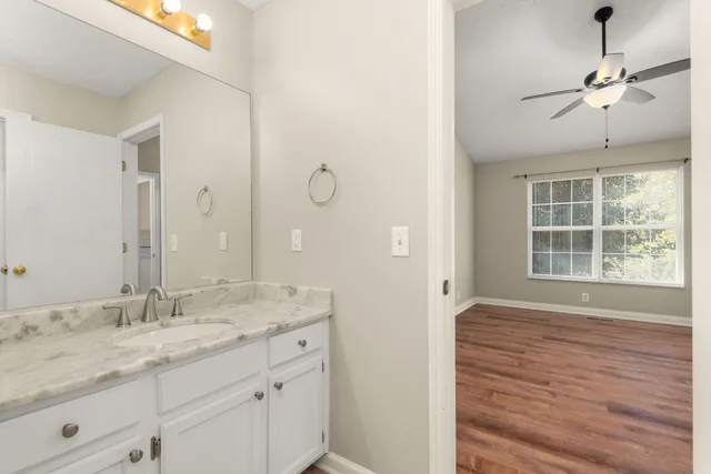 a bathroom with a granite countertop sink mirror and double