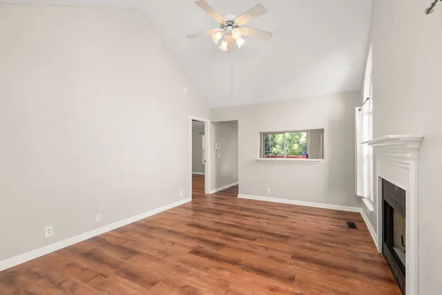 wooden floor in an empty room with a fireplace