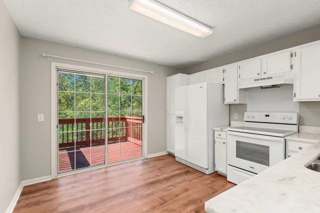 a view of kitchen with furniture wooden floor and window