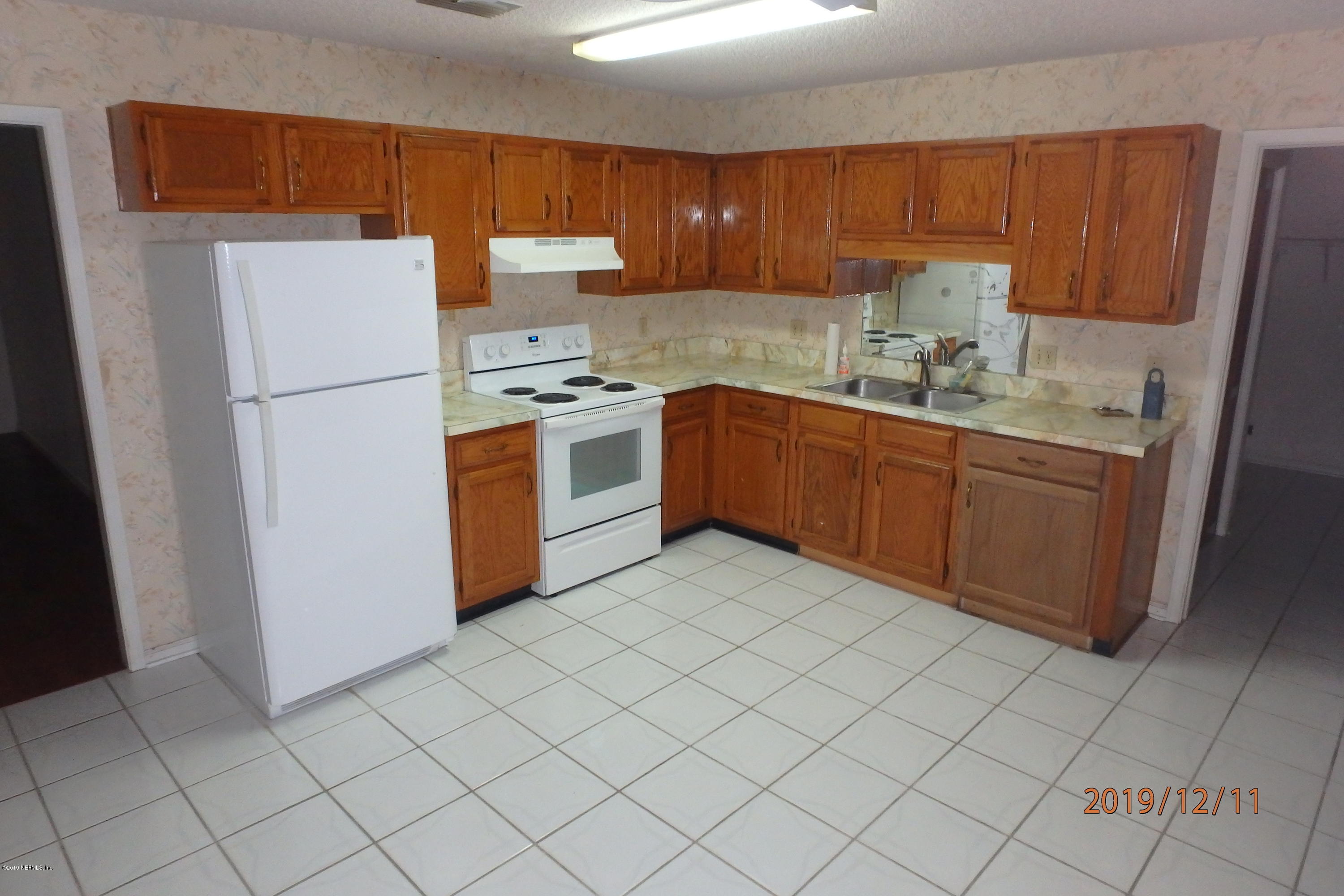 2064 Derringer Road Jacksonville, FL 32225 - Photo 5 of 17 a kitchen with stainless steel appliances granite countertop a refrigerator sink and cabinets
