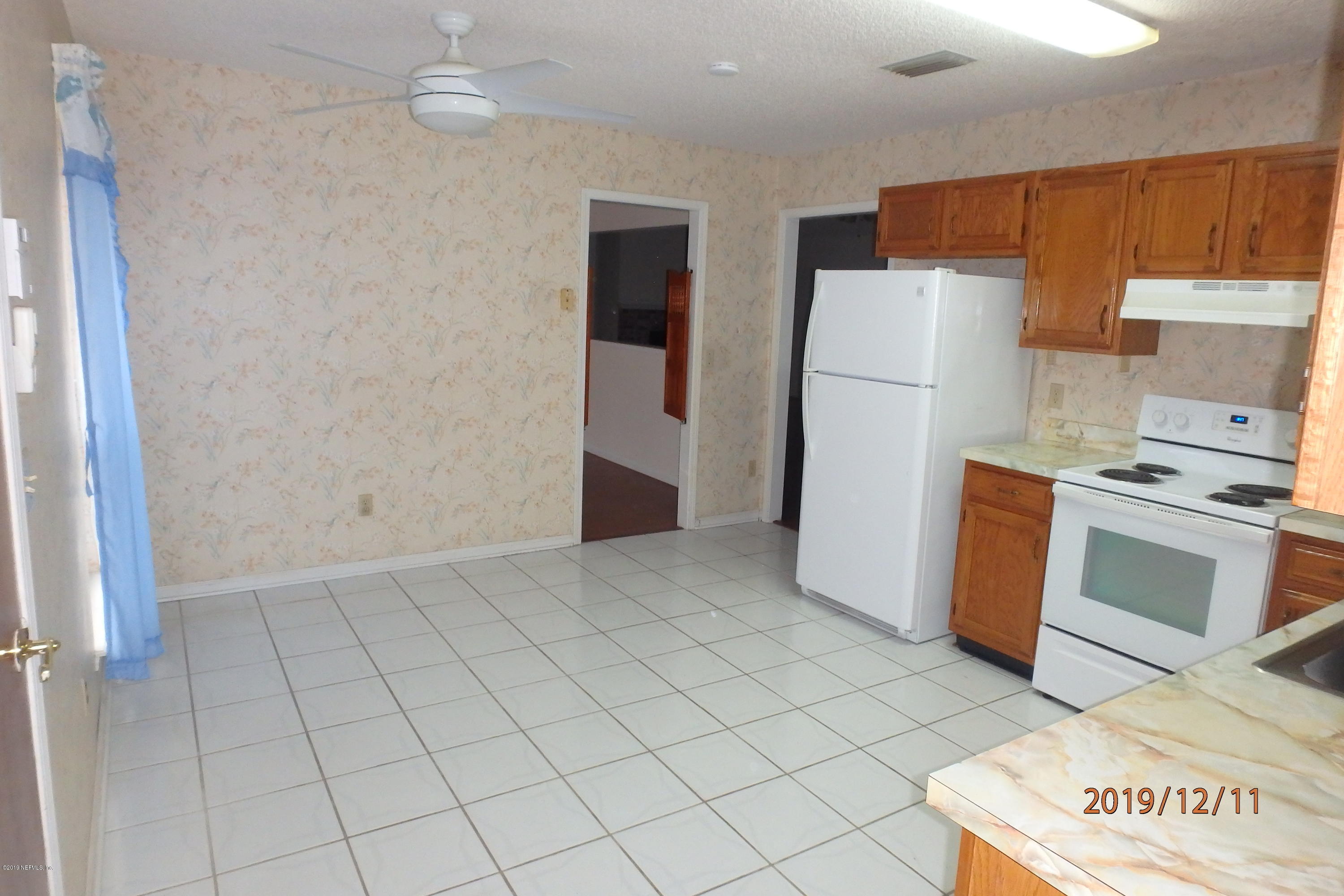 2064 Derringer Road Jacksonville, FL 32225 - Photo 6 of 17 a kitchen with stainless steel appliances a refrigerator and a stove top oven