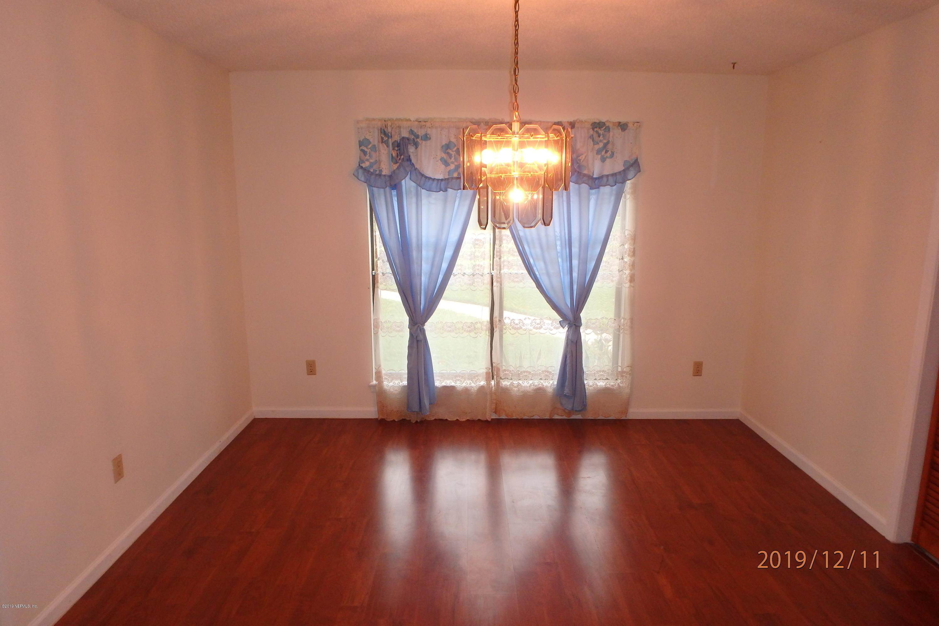 2064 Derringer Road Jacksonville, FL 32225 - Photo 7 of 17 a view of empty room with wooden floor and fan