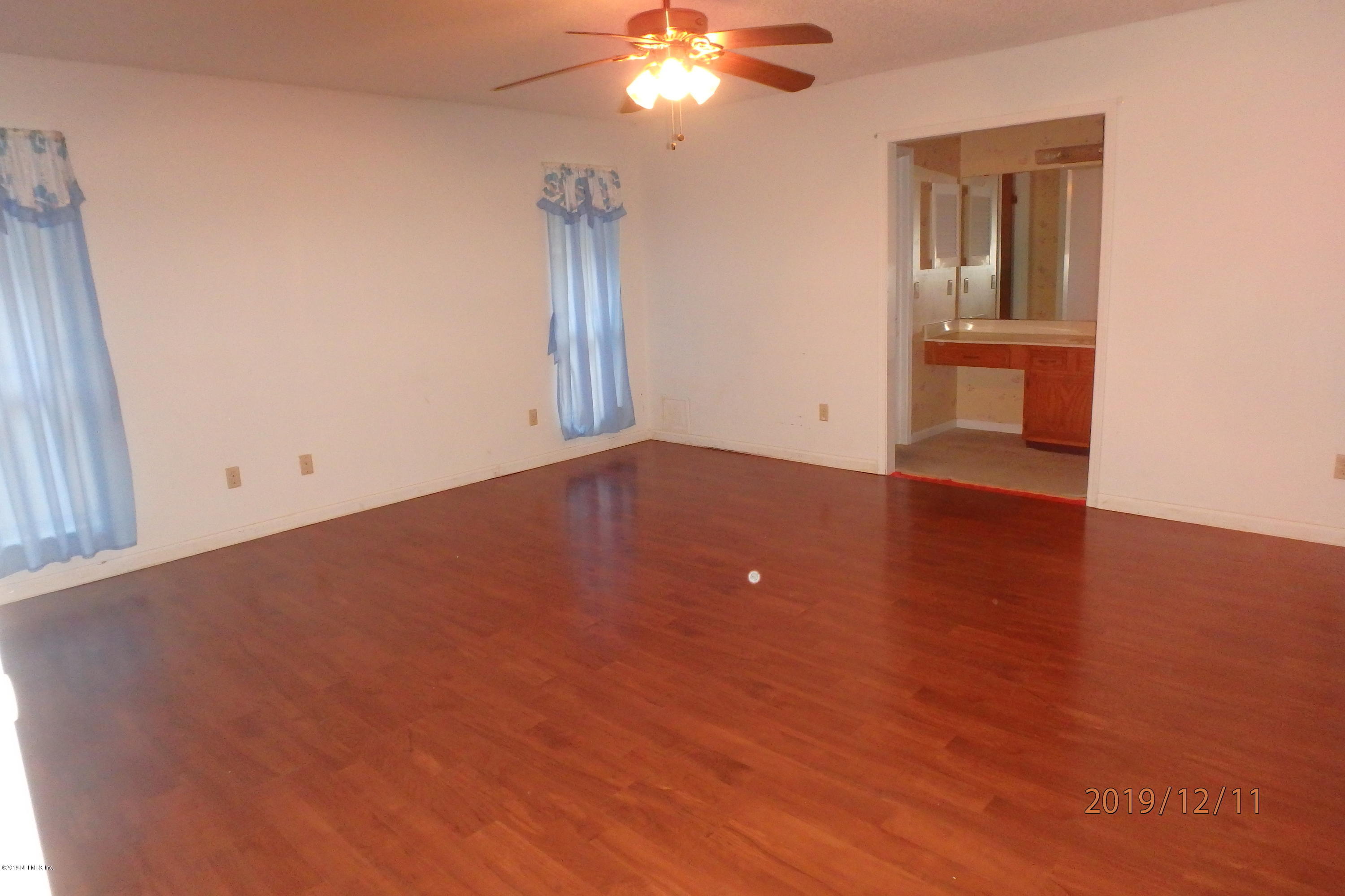 2064 Derringer Road Jacksonville, FL 32225 - Photo 8 of 17 wooden floor in an empty room with a window
