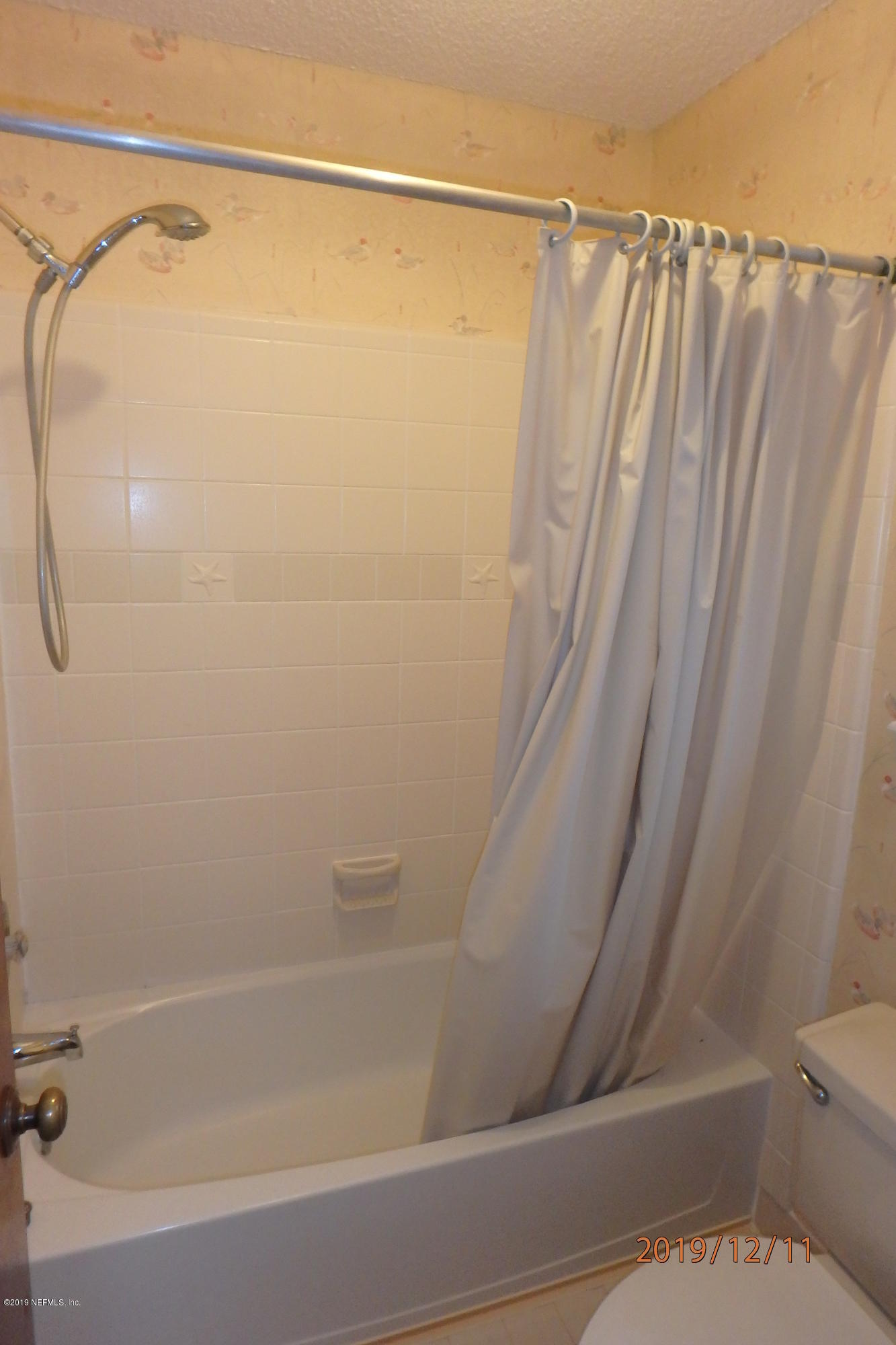 2064 Derringer Road Jacksonville, FL 32225 - Photo 9 of 17 a bathroom with a shower and a toilet