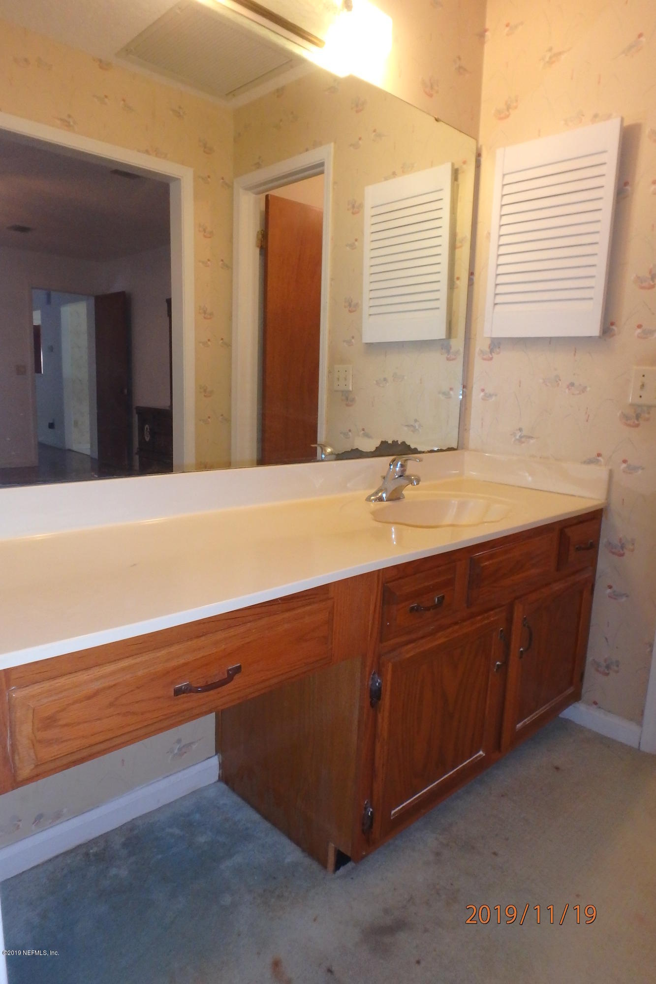 2064 Derringer Road Jacksonville, FL 32225 - Photo 10 of 17 a bathroom with a sink and a mirror