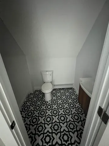 a bathroom with a black white checkered floor