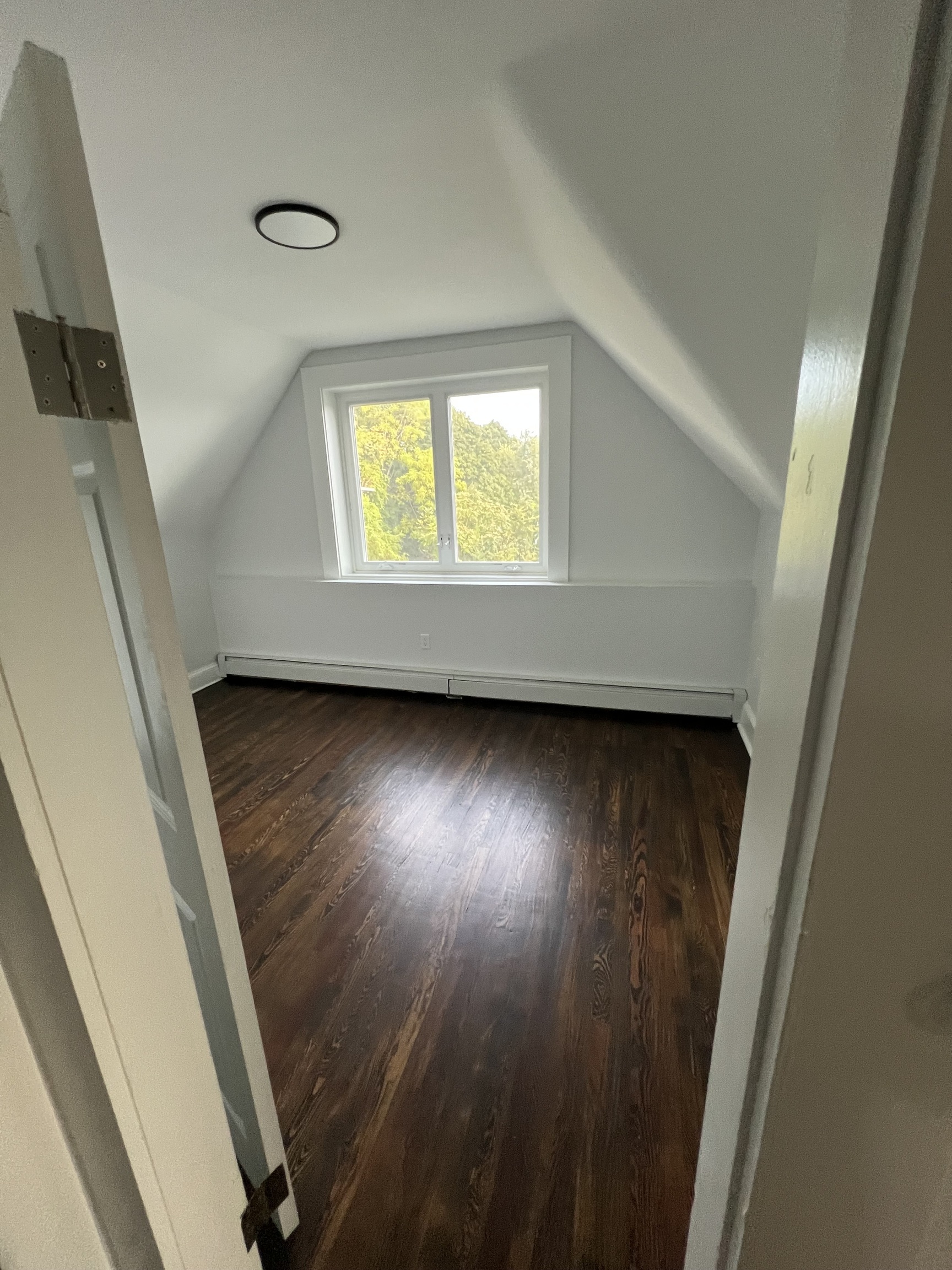 185 Maple Street, Unit 3 New Britain, CT 06051 - Photo 3 of 13 a view of room with wooden floor and window