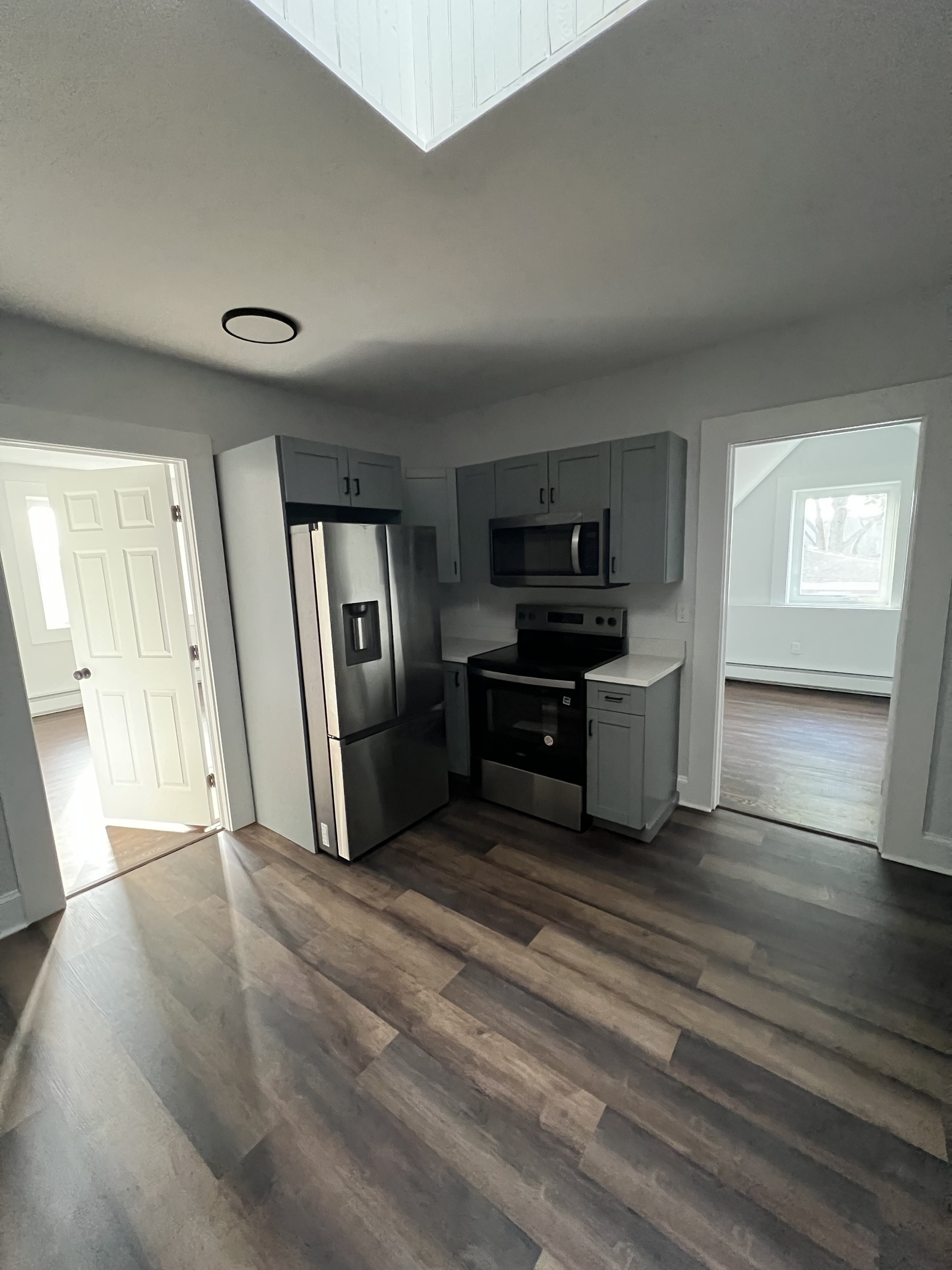 185 Maple Street, Unit 3 New Britain, CT 06051 - Photo 6 of 13 a living room with stainless steel appliances kitchen island granite countertop a refrigerator and a stove top oven