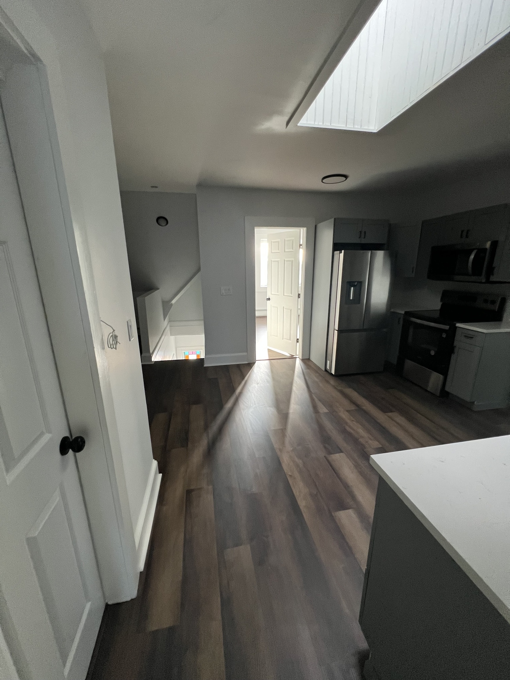 185 Maple Street, Unit 3 New Britain, CT 06051 - Photo 9 of 13 a view of a hallway with wooden floor and stairs