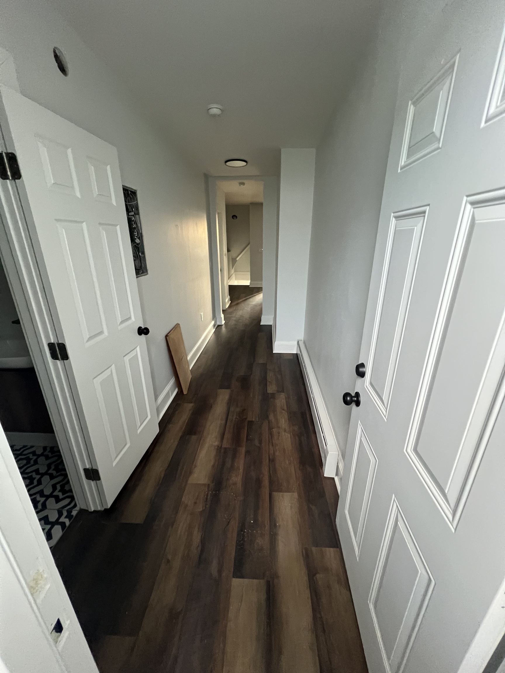 185 Maple Street, Unit 3 New Britain, CT 06051 - Photo 10 of 13 a view of a hallway with wooden floor and staircase