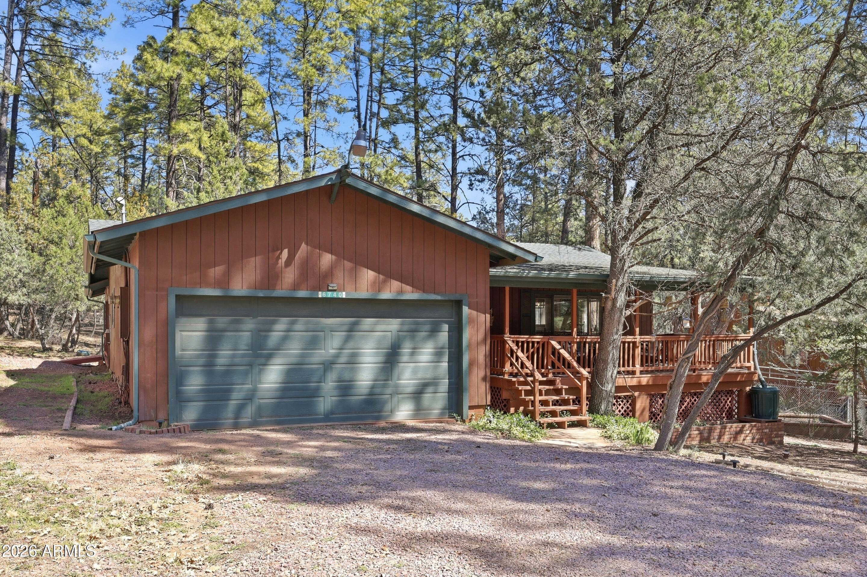 6740 Ridge Road Pine, AZ 85544 - Photo 1 of 35 a front view of a house with a yard and garage