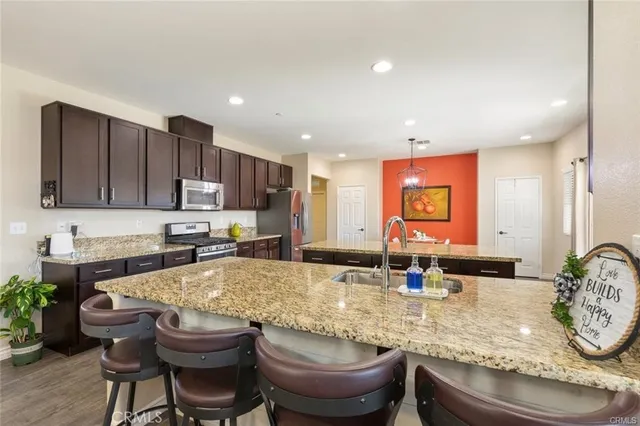 a kitchen with large white cabinets and chairs