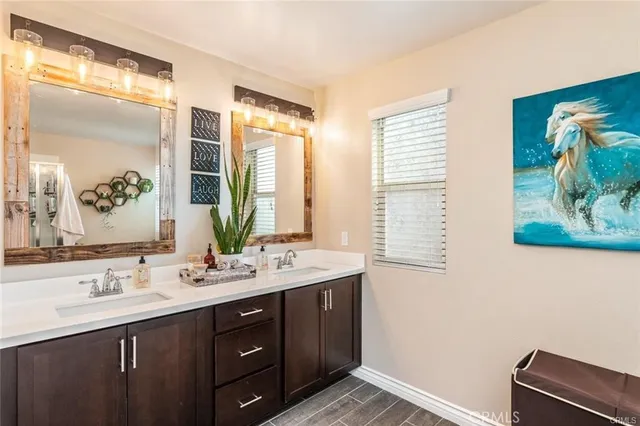 a bathroom with a double vanity sink and a mirror