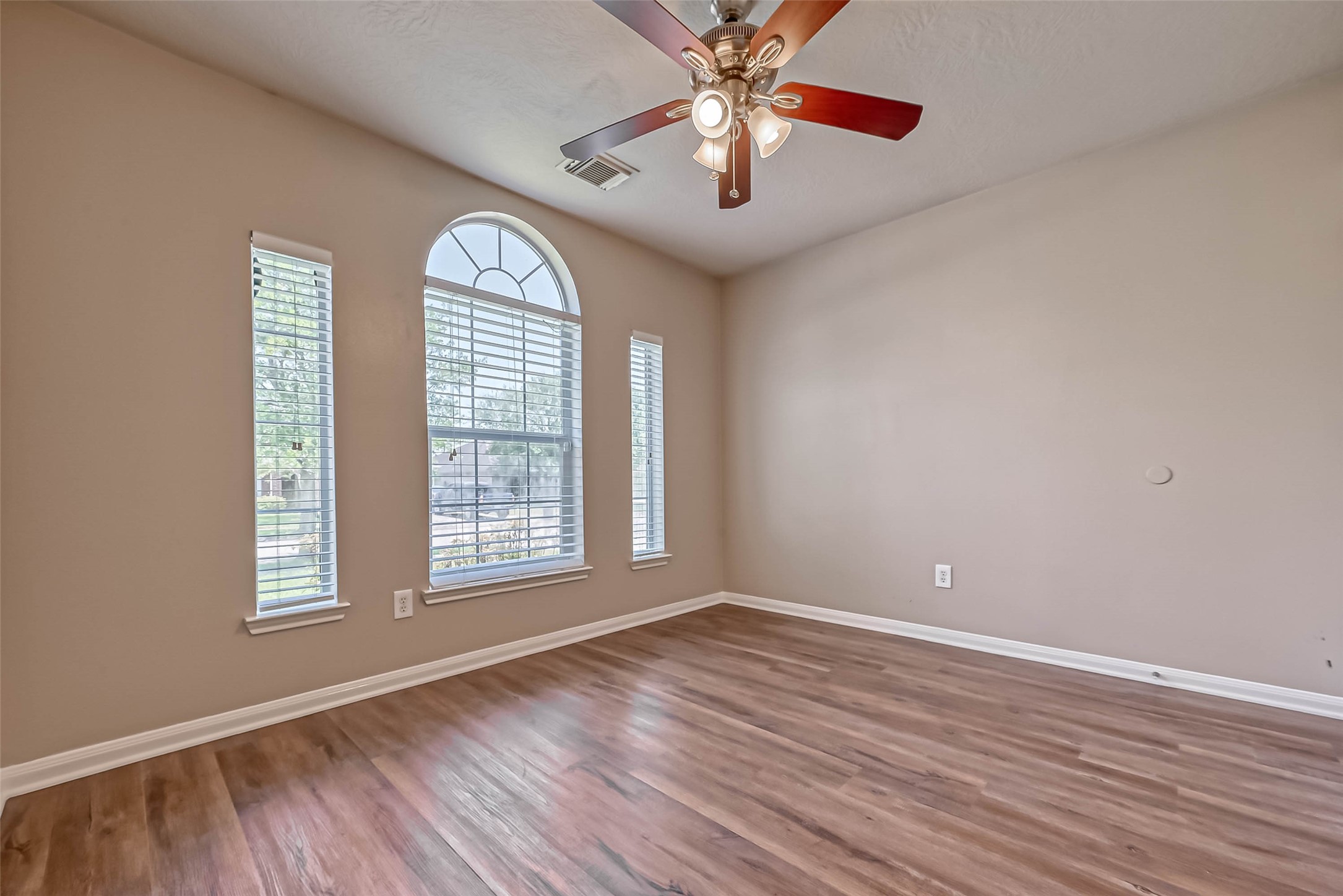 911 Bent Sail Lane League City, TX 77573 - Photo 15 of 34 an empty room with wooden floor chandelier fan and windows