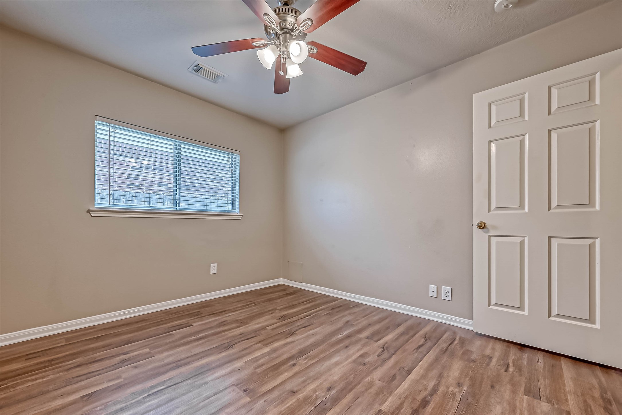 911 Bent Sail Lane League City, TX 77573 - Photo 20 of 34 a view of an empty room with wooden floor and a window