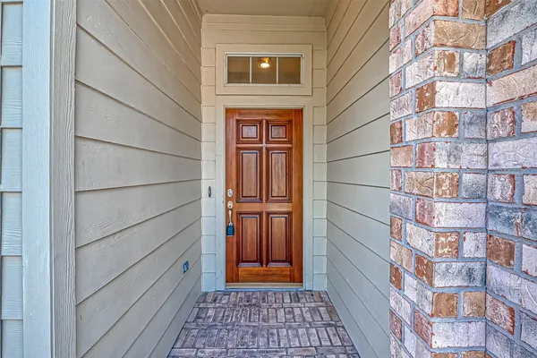 a view of a brick house with a door and a window