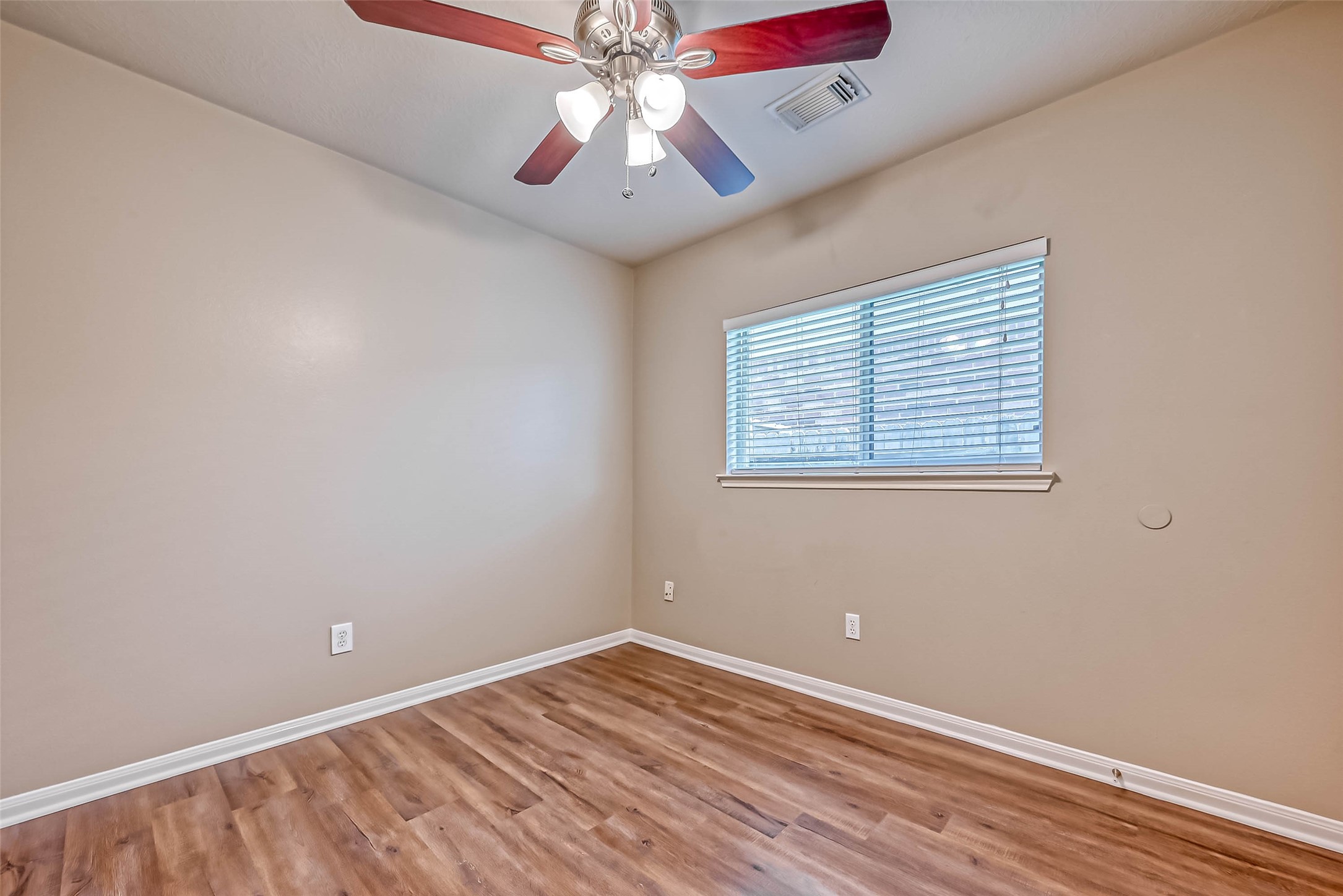 911 Bent Sail Lane League City, TX 77573 - Photo 23 of 34 an empty room with a window and a fan