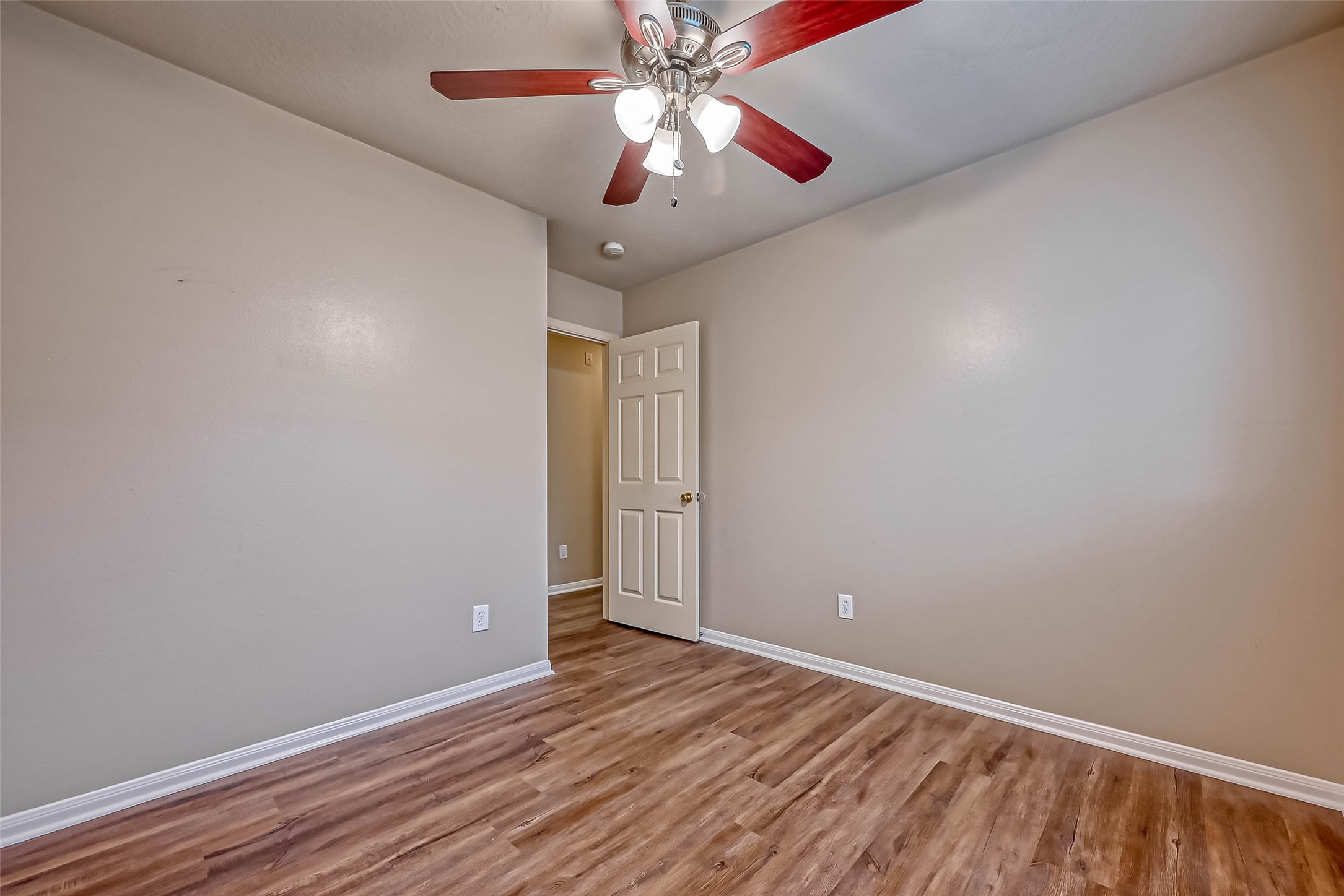 911 Bent Sail Lane League City, TX 77573 - Photo 24 of 34 a view of an empty room with window and wooden floor