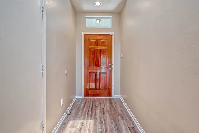 a view of a hallway with wooden floor