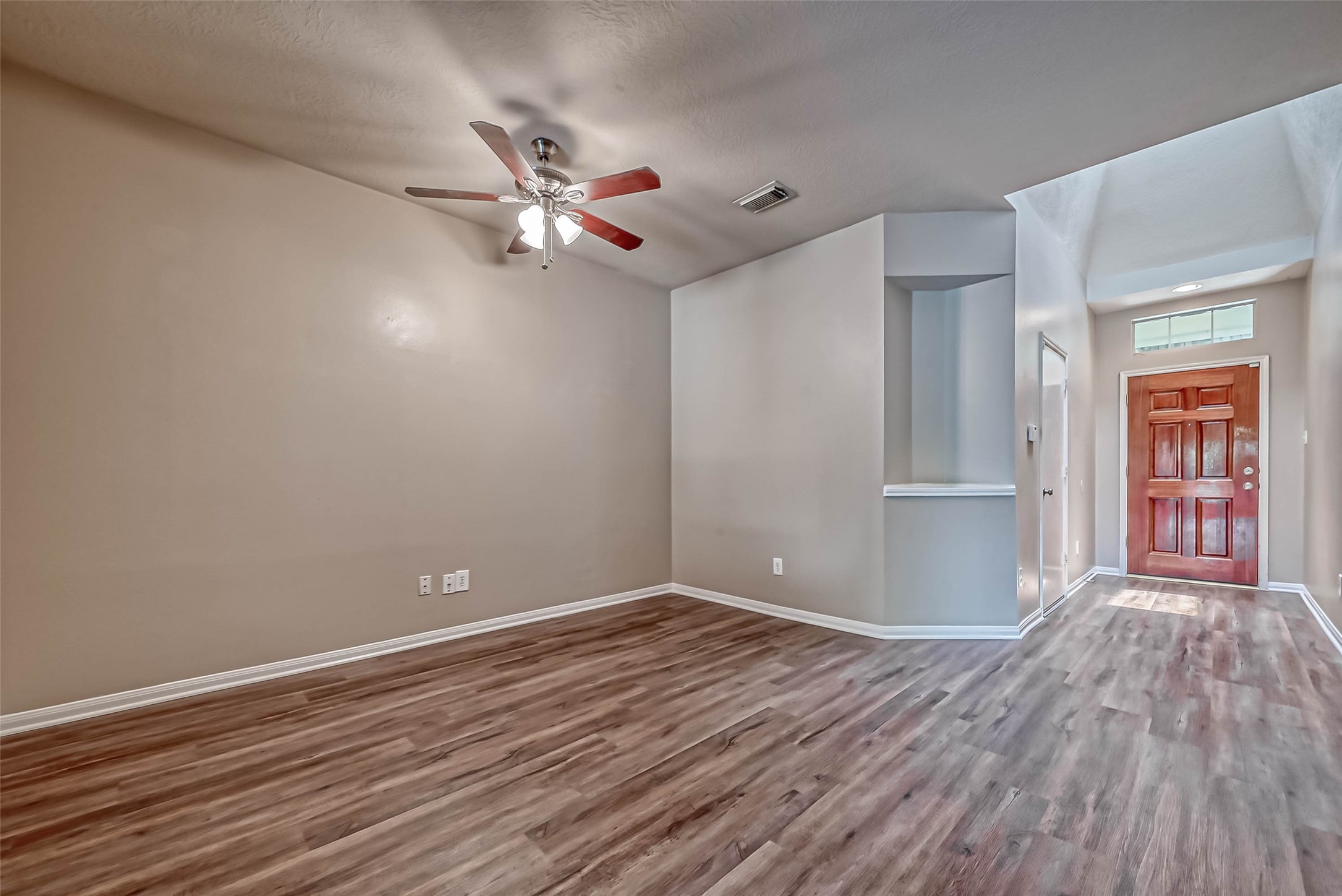 911 Bent Sail Lane League City, TX 77573 - Photo 4 of 34 a view of empty room with wooden floor and fan