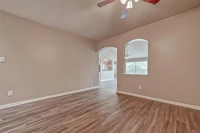 wooden floor in an empty room with a window