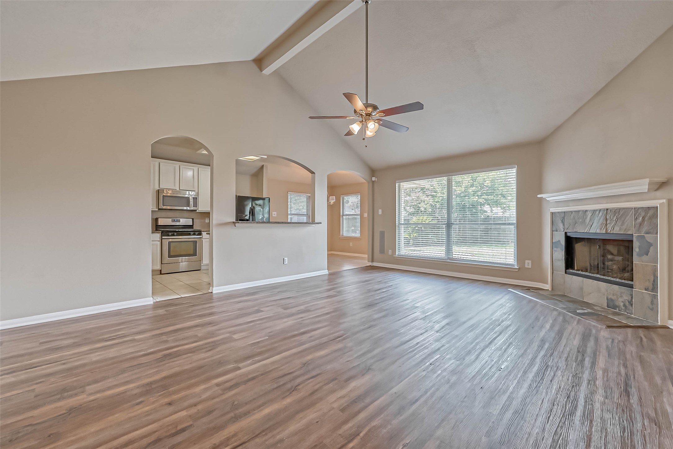 911 Bent Sail Lane League City, TX 77573 - Photo 8 of 34 an empty room with wooden floor fireplace and windows