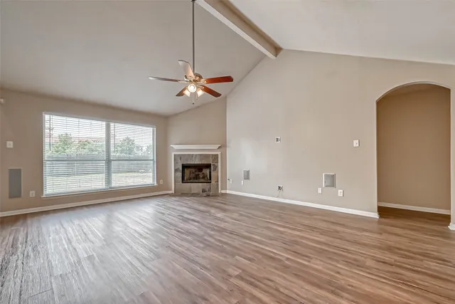 wooden floor chandelier and windows in an empty room