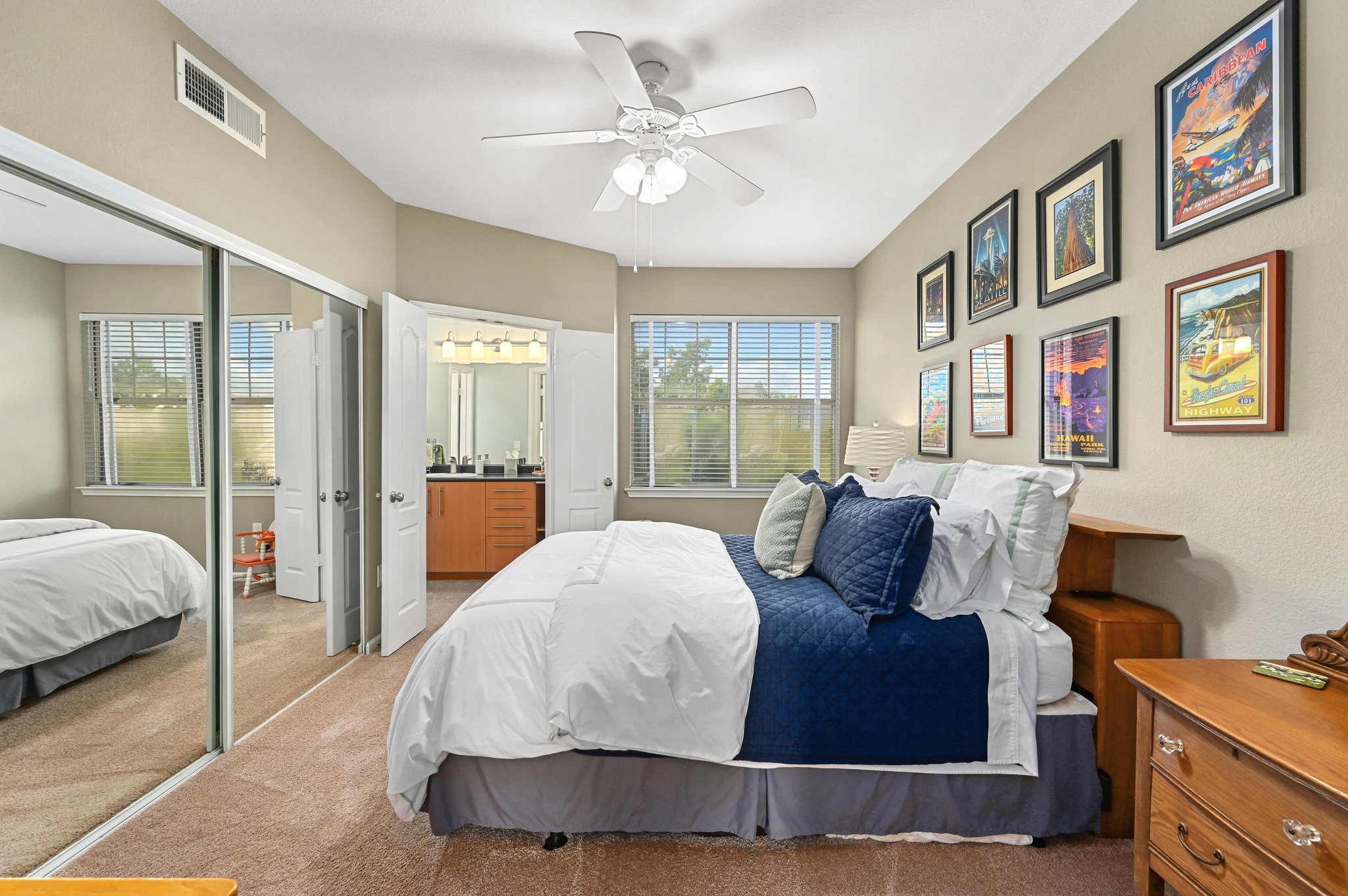 11203 Ranch Road 2222, Unit 1104 Austin, TX 78730 - Photo 16 of 23 Bedroom with carpet floors, a closet, connected bathroom, and a ceiling fan