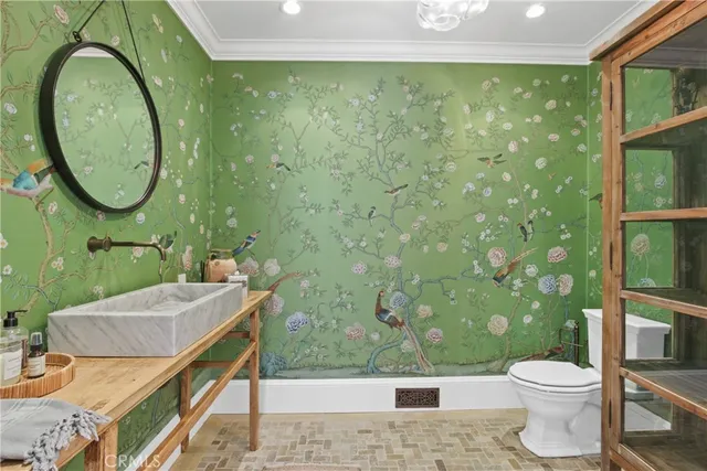 a bathroom with a toilet a sink and a mirror