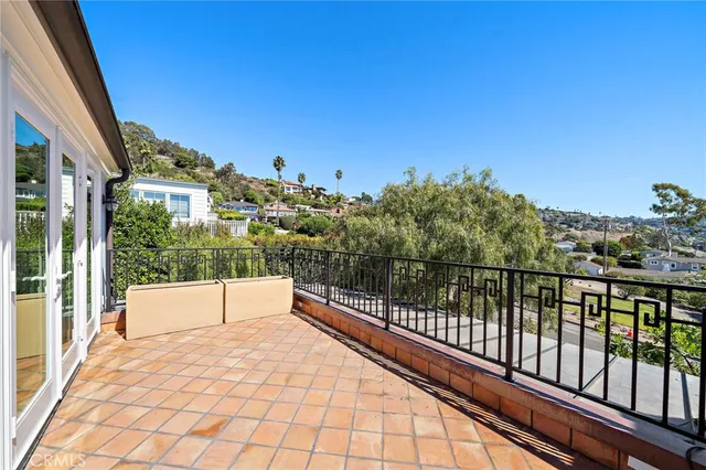 a view of balcony with mountain view and wooden floor