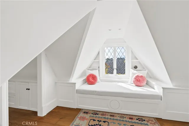 a bedroom with a bed and window