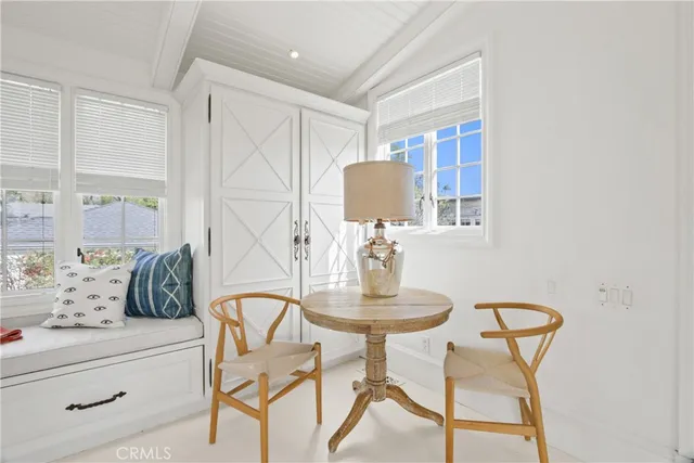 a view of a dining room with furniture and a window