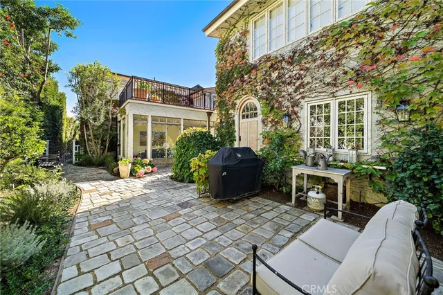 a view of a house with backyard sitting area and furniture