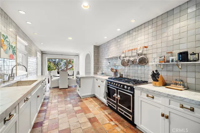 a kitchen with a sink stove and cabinets