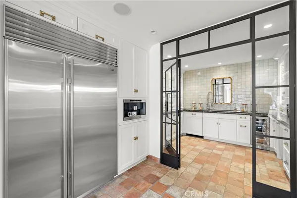a large bathroom with a glass shower door and a mirror