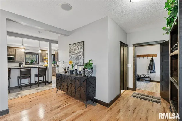 a kitchen with cabinets and chairs