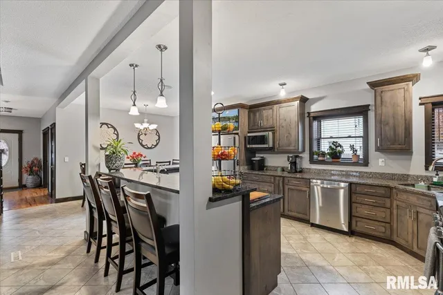 a kitchen with stainless steel appliances granite countertop a sink and stove