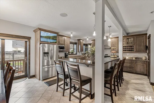 a view of a dining room with furniture and chandelier