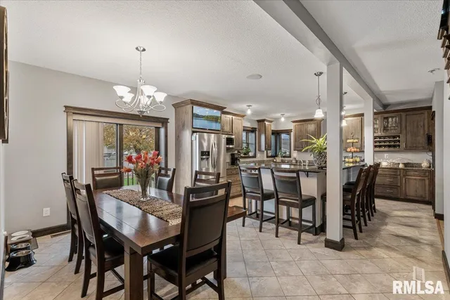 a large bedroom with a bed and a chandelier
