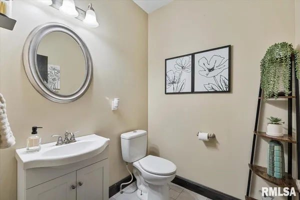 a bathroom with a granite countertop sink a mirror a toilet and shower