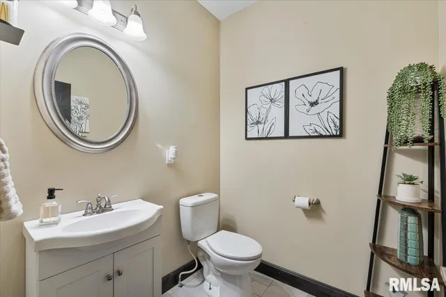 a bathroom with a granite countertop sink a mirror a toilet and shower