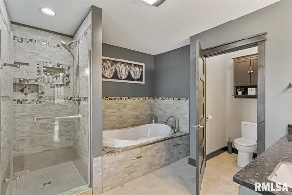 a bedroom with a bed and a large mirror