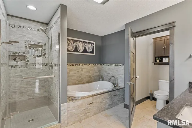 a bedroom with a bed and a large mirror